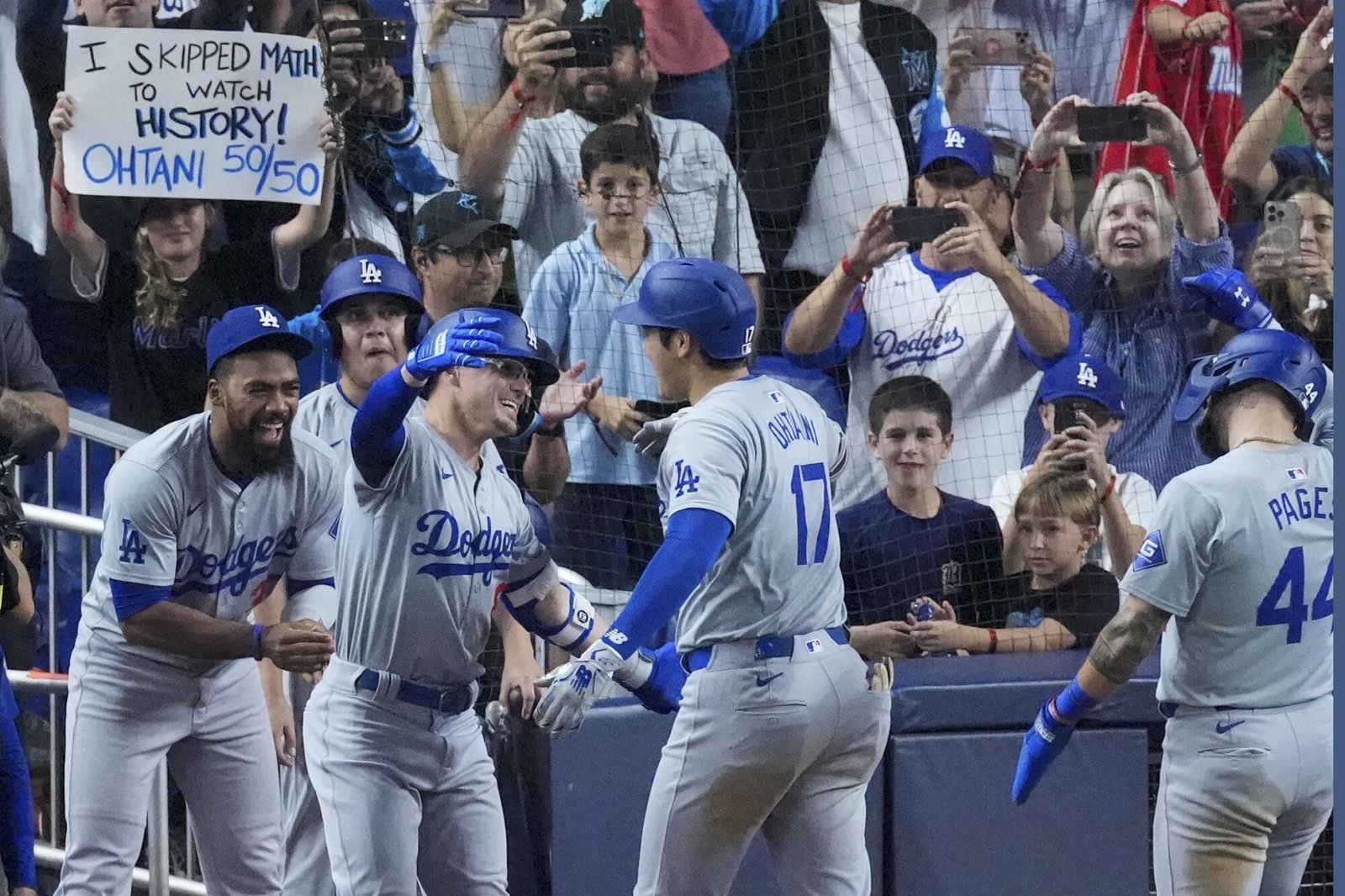 Shohei Ohtani celebrating with his Dodger team for getting fifty home runs and fifty stolen bases.